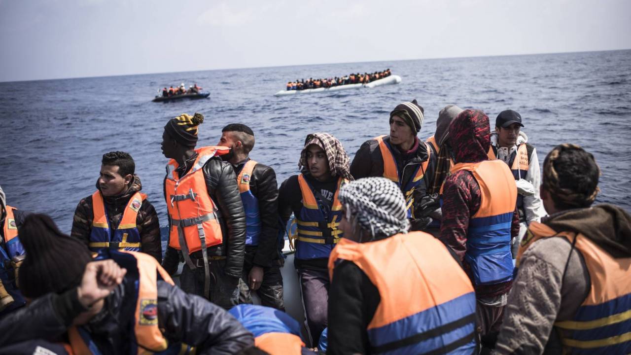 A boat carrying refugees in the middle of the sea