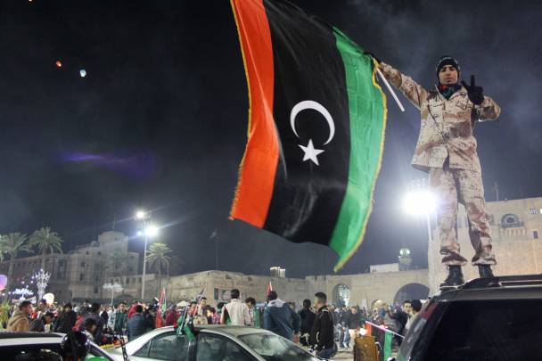 A militia man with a Libyan flag in downtown Tripoli. 